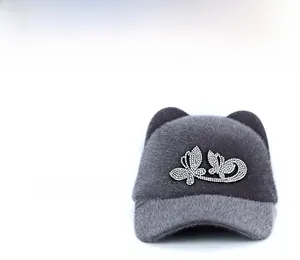 Detail of grey faux mink fur equestrian hat with rhinestone bow and cat ears