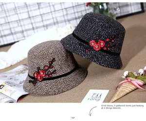 Detail of tweed bucket hats featuring floral embroidery and rhinestone accents for winter