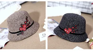Detail of tweed bucket hats featuring floral embroidery and rhinestone accents for winter