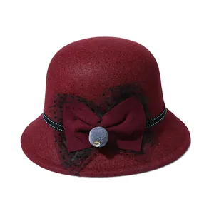 Women's burgundy wool felt bowl hat with mesh bow and plush ball decoration