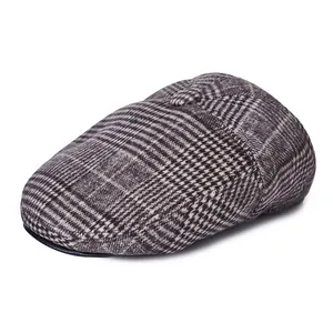 Detail of classic glen check patterned ivy cap with a fabric button and reinforced brim