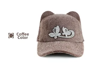Detail of coffee brown plush baseball cap featuring cat ears and rhinestone butterfly
