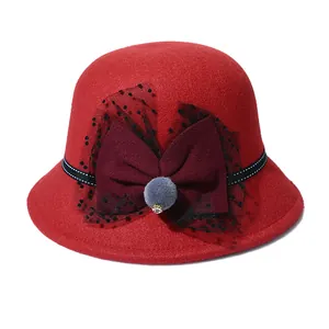 Red wool felt cloche hat for women featuring burgundy bow, black mesh and grey fur pompom