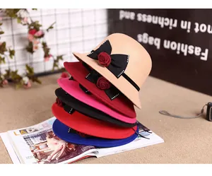 Detail of elegant felt fedora hats featuring side bows and crystal flower accents