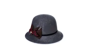 Detail of dark grey felt hat featuring a decorative brown bow with sparkling rhinestones