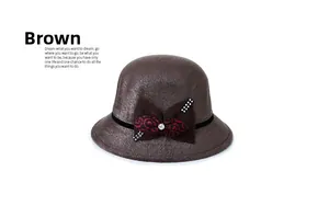 Detail of brown wool hat with rhinestone bow decoration and black ribbon trim