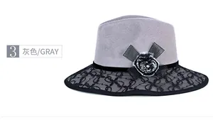 Close-up of grey wool fedora hat with black floral lace brim and velvet ribbon detail