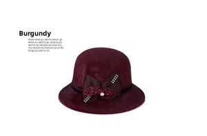 Detailed view of wine red wool cloche hat with rhinestone-embellished bow and swirl pattern