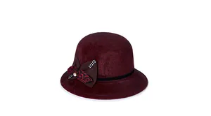 Close-up of elegant burgundy wool felt hat with rhinestone bow and swirl pattern band