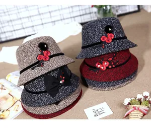 Detailed view of winter cloche hats with floral embroidery and decorative rhinestones