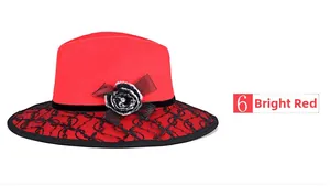 Detail of red wool felt fedora featuring black lace embroidery and plush floral trim