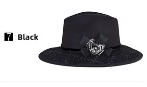 Detail of elegant black wool fedora featuring delicate lace embroidery and a bow