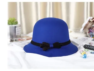 Detail of wool felt dome hat in royal blue featuring a black ribbon bow tie