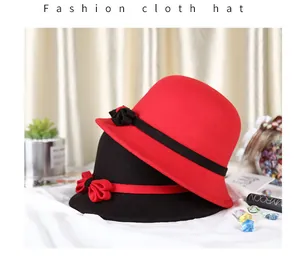 Close-up of vintage wool cloche hats in red and black with elegant ribbon bows