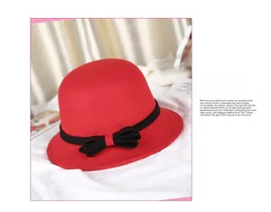 Detail of red wool felt cloche hat with a black ribbon bow and vintage style