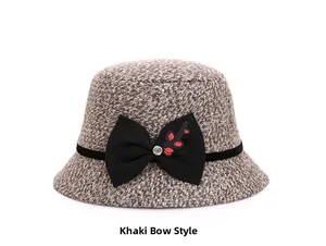 Detailed texture of khaki wool bucket hat featuring black bow, rhinestone and embroidery