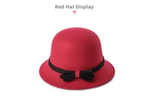 Detail showing red wool felt bucket hat with a classic black ribbon bow decoration