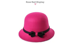 Detail of rose red wool felt cloche hat for women with a black ribbon bow decoration