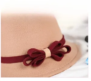 Detailed close-up of wool felt dome hat with burgundy ribbon and elegant bow accent