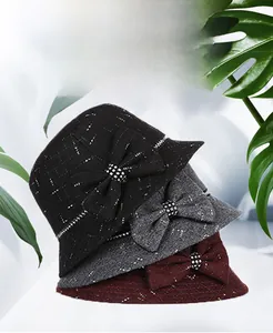 Detail of wool cloche hats for women featuring elegant bows and sparkling rhinestone accents