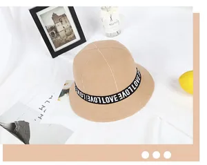 Close-up of khaki wool bucket hat featuring decorative LOVE letter embroidery