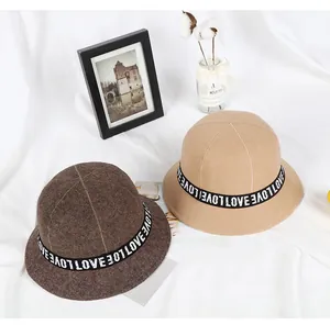 Detail of wool cloche hats in coffee and khaki with LOVE ribbon band decoration