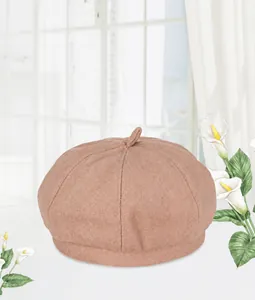 Detail of soft pink wool beret with small top tail design for autumn and winter fashion