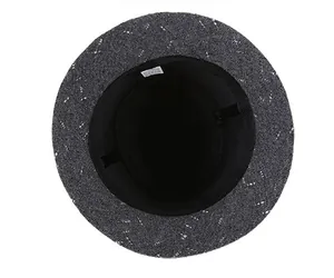 Detail view of the elegant grey tweed fedora hat showing inner black lining and wash label