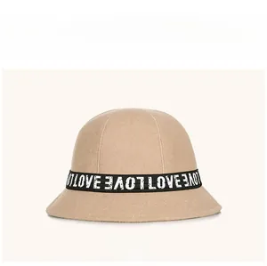 Detailed close-up of khaki wool bucket hat featuring decorative LOVE letter ribbon