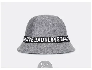 Detailed close-up of light grey wool bucket hat with LOVE embroidered ribbon detail
