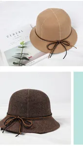 Detail of wool fedora hats with delicate leather bow tie and thick fabric texture