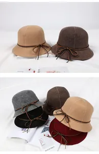 Detail of wool cloche hats with leather bow straps in five classic autumn colors