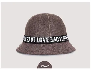 Detail of the brown wool felt bucket hat with a black LOVE ribbon and soft texture