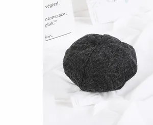Close-up of thick grey wool felt beret showing textured fiber detail and retro mushroom shape