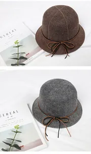 Detail of winter wool bucket hats in coffee and grey with thin leather bow accents