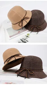 Close-up of vintage wool bucket hat with delicate leather bow tie and soft felt texture