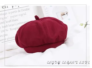 Detailed close-up of wine red wool beret cap with classic top stalk for winter fashion