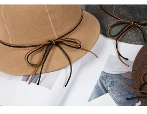 Detailed texture of wool felt bucket hats in camel, grey and coffee with ribbon bow tie