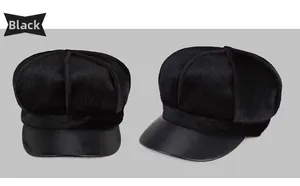Detail view of black newsboy cap featuring fluffy faux fur body and smooth leather brim