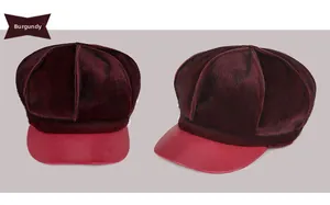 Detail of wine red newsboy cap with plush faux fur crown and smooth leather brim