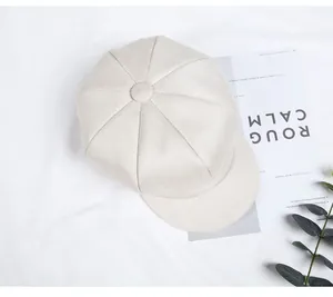 Top view of cream white newsboy cap with classic eight-panel wool texture design