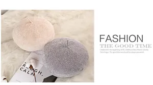 Detail of knitted wool texture on beige and gray beret hats with top stem decoration