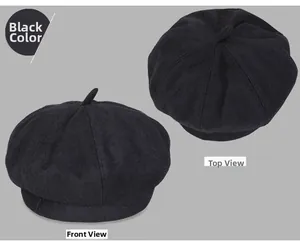 Detail of a black wool beret showing the top stalk and side view with thick felt fabric