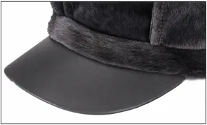 Detail of faux fur textures and matte leather brim on a stylish winter newsboy hat