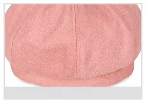 Close-up of soft pink wool beret fabric texture and high-quality stitching details