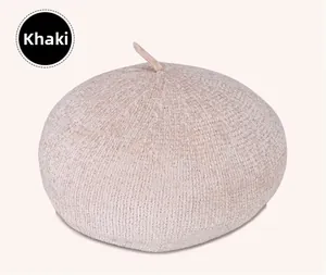Macro shot of khaki beret hat featuring textured bouclé knit and small top stem detail