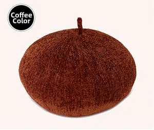 Detail of coffee brown knitted beret with a textured knit fabric and top stem