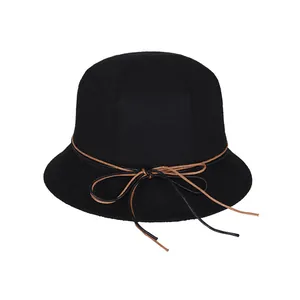 Elegant black wool cloche bucket hat featuring a vintage wavy brim and bow tie detail