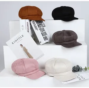 Detailed view of assorted newsboy caps in five colors on a white tiered display