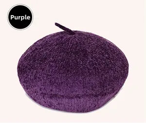 Detailed top view of purple knitted beret with textured fabric and top stem detail